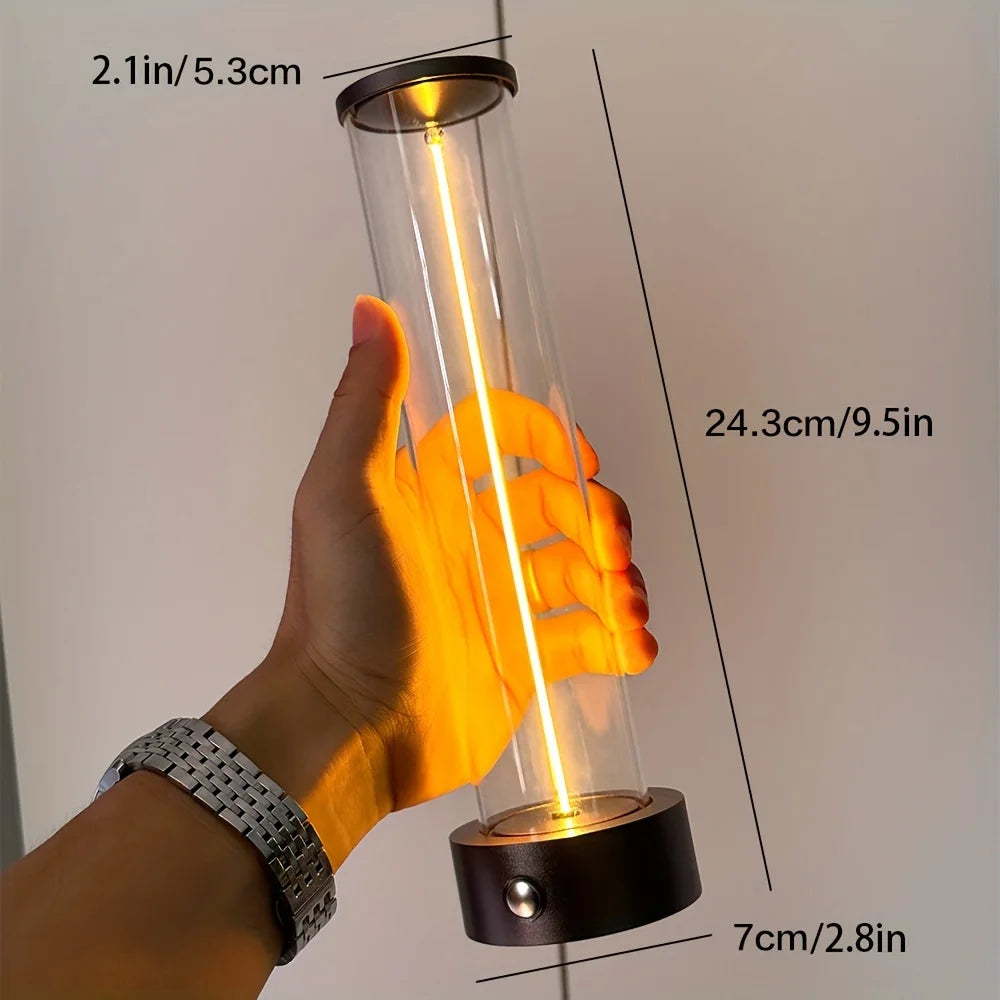 Hand holding a cylindrical light bulb with measurements indicated