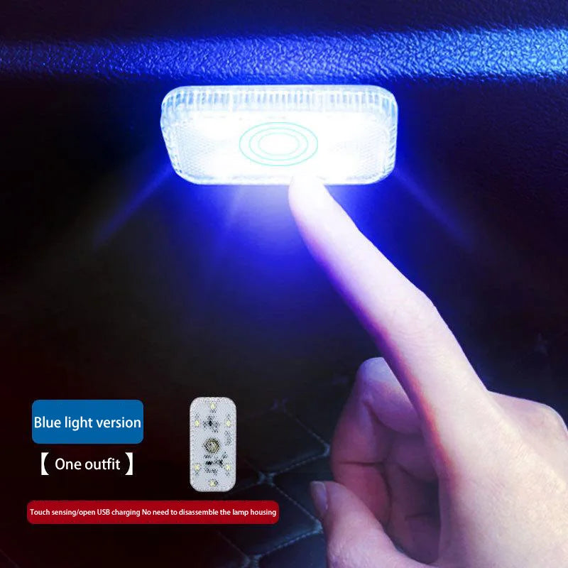 Hand holding a blue light-emitting device against a dark background