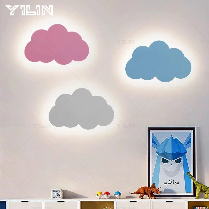Three cloud-shaped wall lights on a wall with a framed picture and toys below.