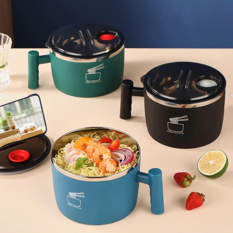 Three portable noodle cookers on a table with food and fruits.