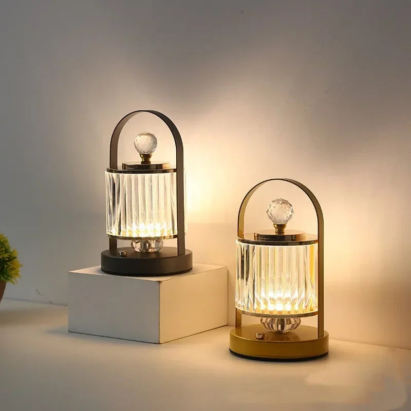 Two decorative table lamps with glass shades on a neutral background