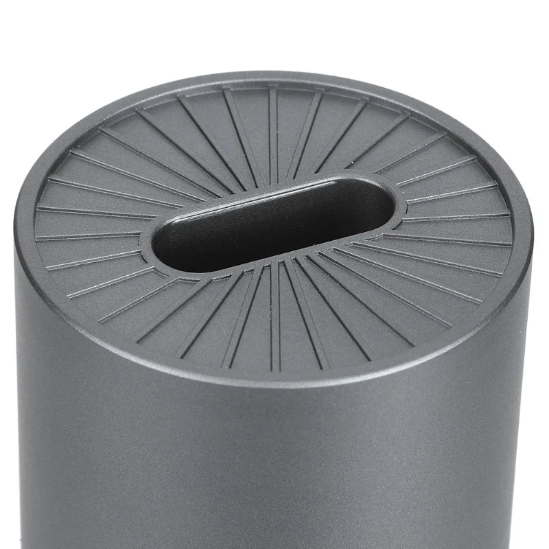 Gray cylindrical trash can with textured lid on a white background