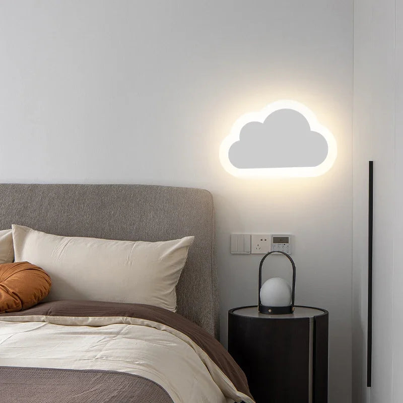 Cloud-shaped wall light in a bedroom setting with a bed and nightstand.